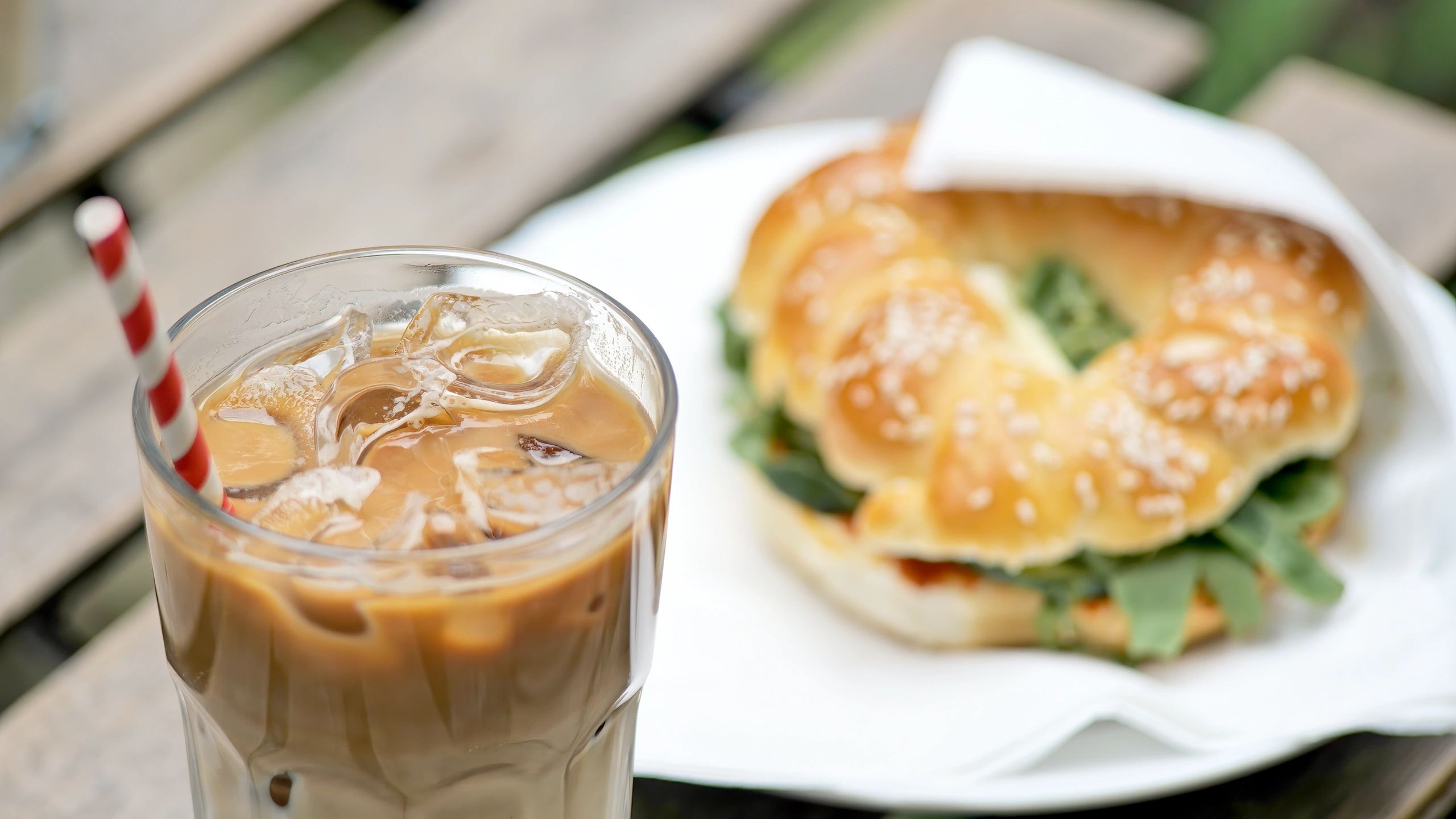Iced coffee and sandwich from a cafe counter
